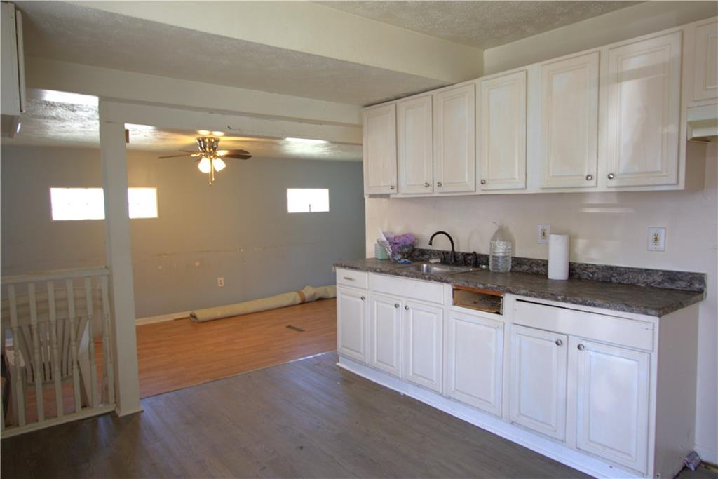 233 Allen Avenue Donora, PA 15033 - Photo 5 of 31 Spacious 15x10 Eat-in Kitchen w/ Plenty of Nice White Cabinets & Newer Countertop plus Newer Engineered Life Proof Flooring. Opens nicely to step down into Large Living Room