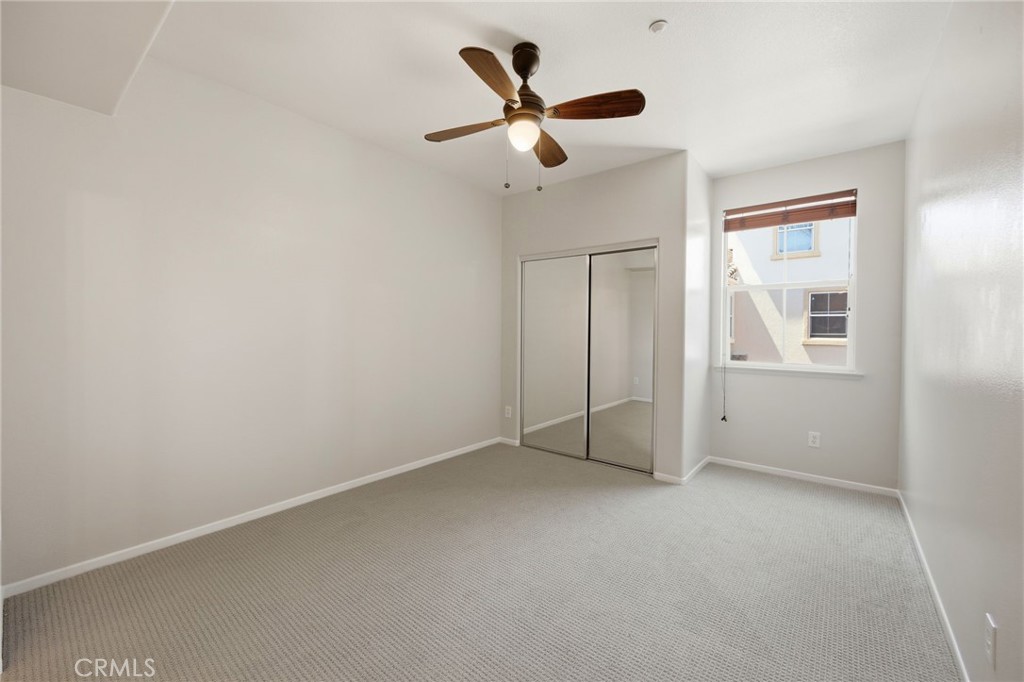 3603 Jetty Carlsbad, CA 92010 - Photo 16 of 43 an empty room with closet and ceiling fan