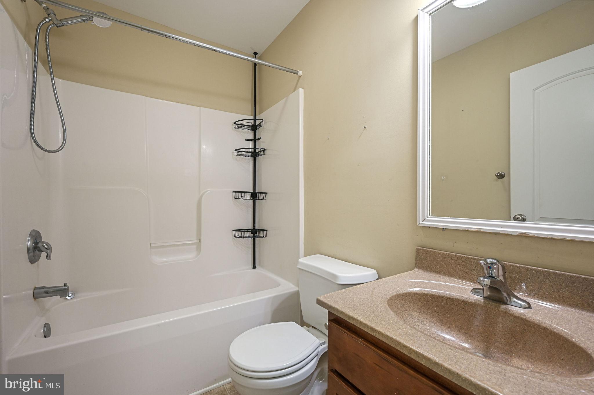 554 Phillips Drive Magnolia, DE 19962 - Photo 23 of 31 a bathroom with a granite countertop sink toilet and shower