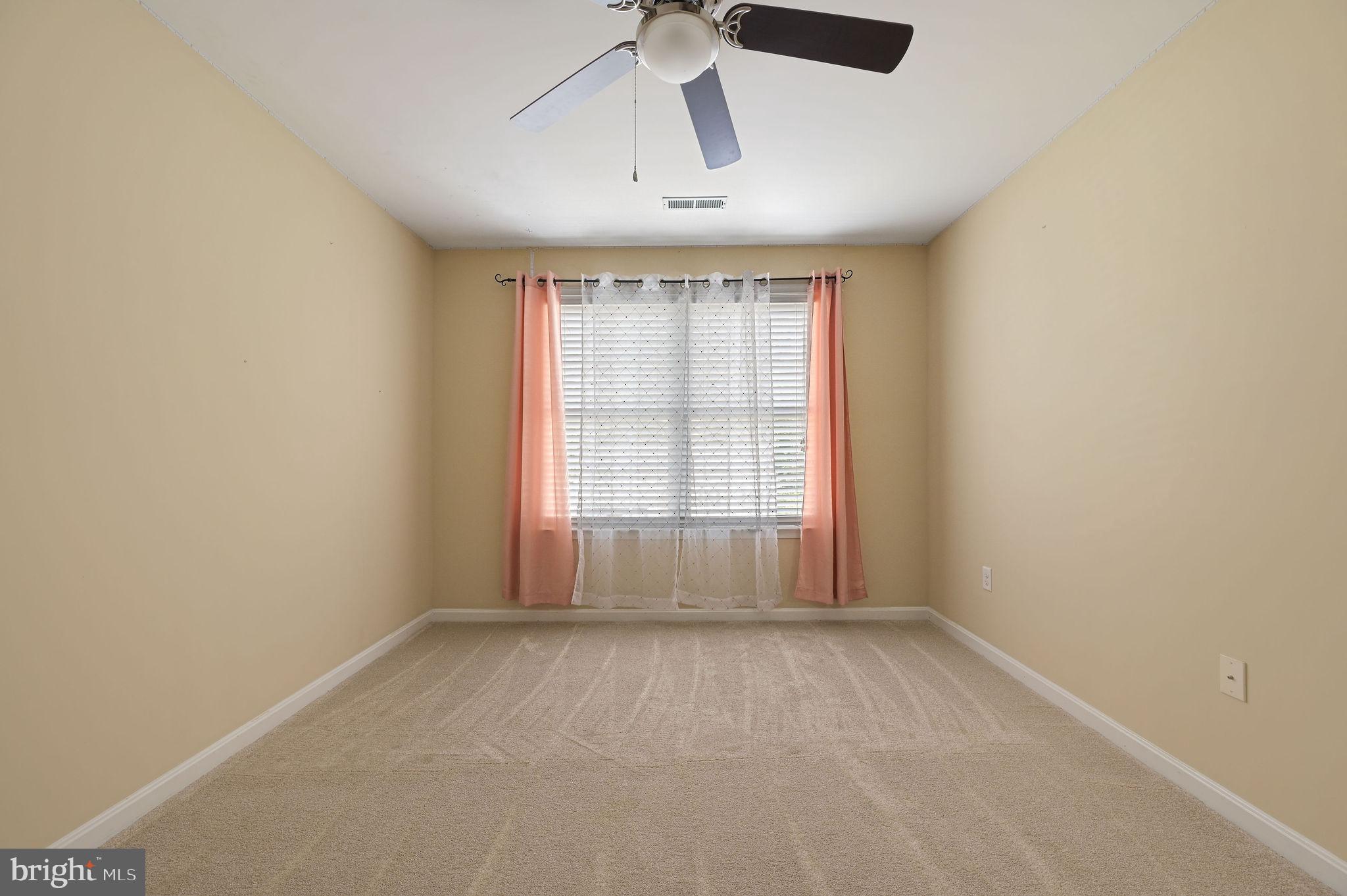 554 Phillips Drive Magnolia, DE 19962 - Photo 26 of 31 an empty room with chandelier fan and windows