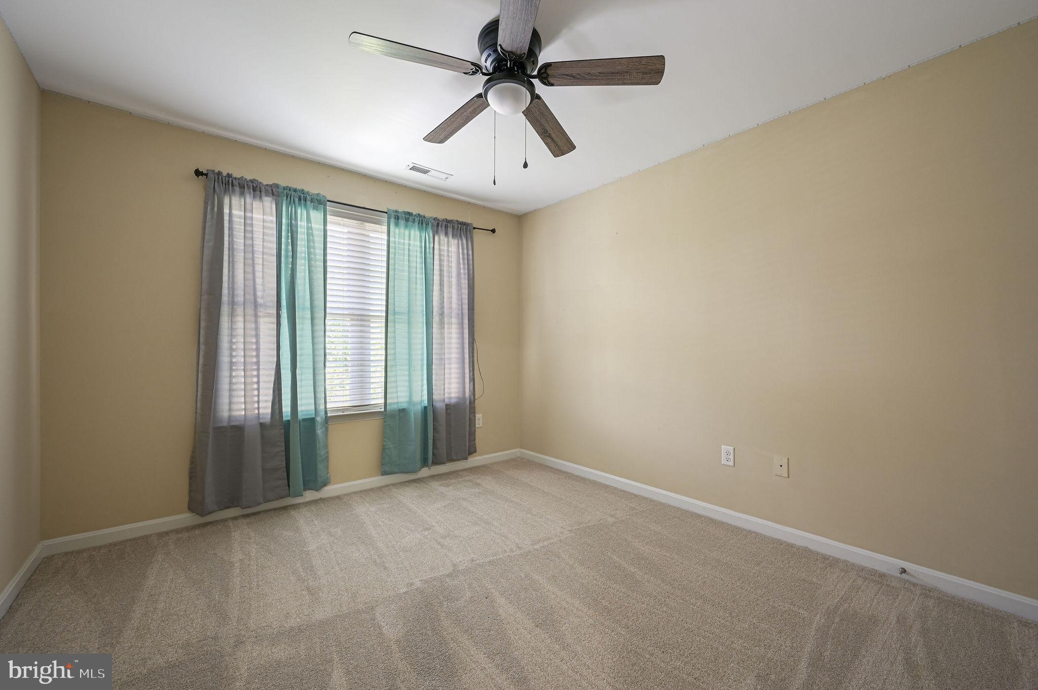 554 Phillips Drive Magnolia, DE 19962 - Photo 28 of 31 an empty room with windows and ceiling fan