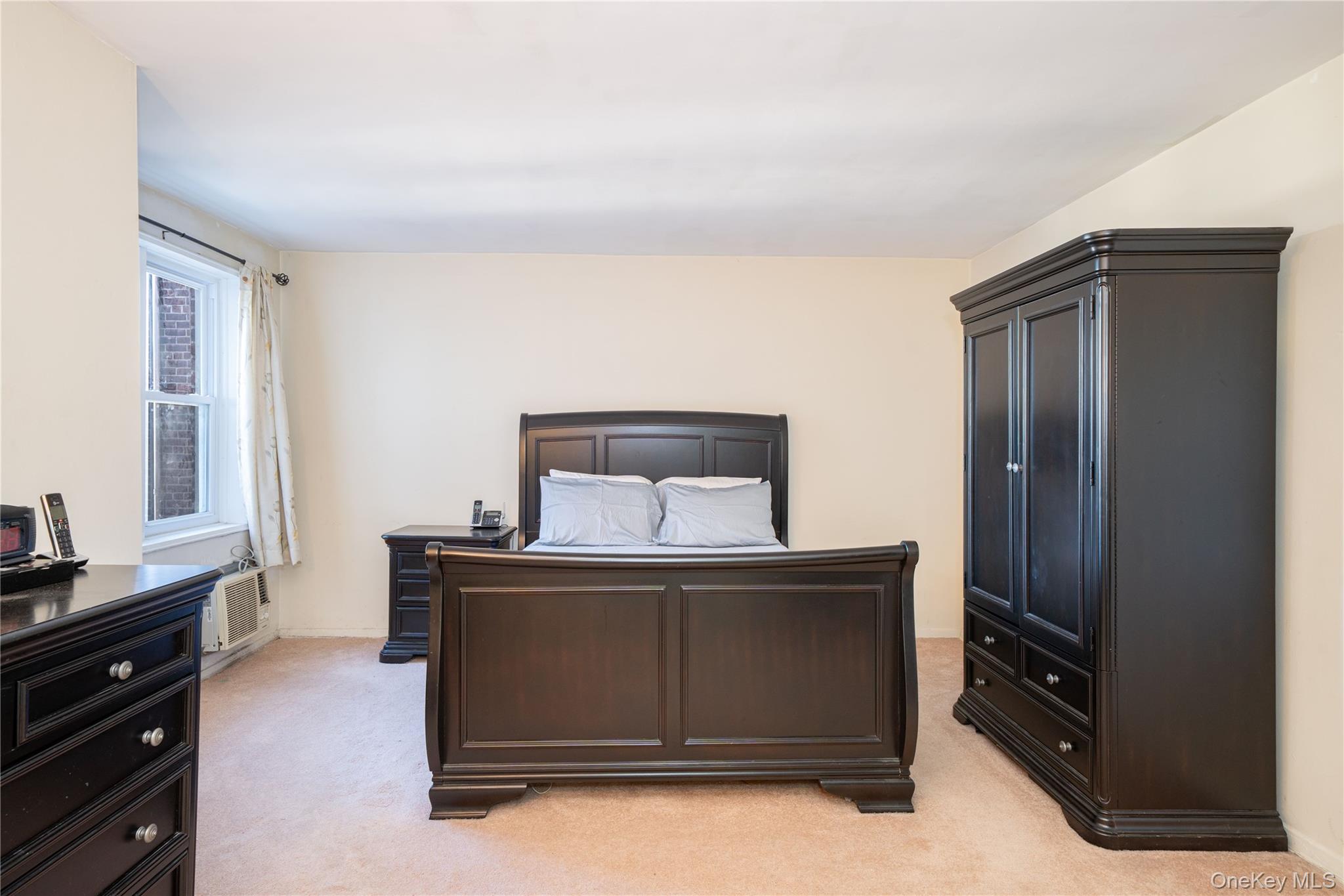 495 Odell Avenue, Unit 8R Yonkers, NY 10703 - Photo 16 of 27 Bedroom with light colored carpet and baseboards