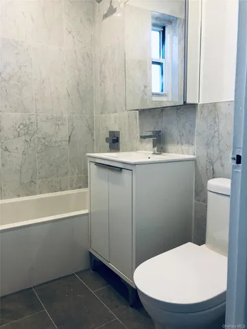 a bathroom with a toilet and a sink