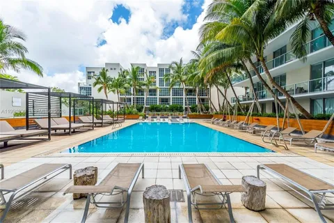 a view of swimming pool with outdoor seating and city view