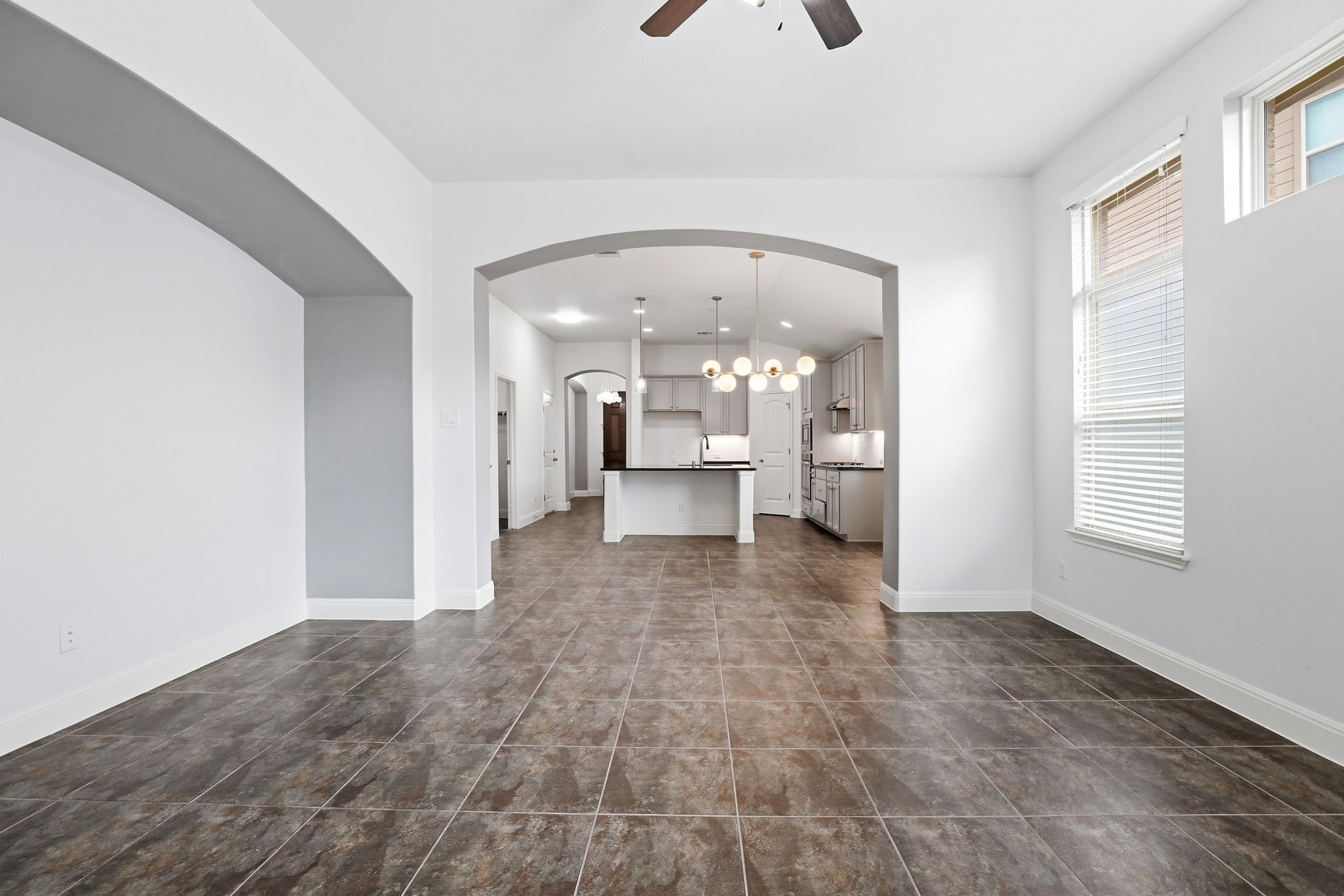152 Stone View Trail Austin, TX 78737 - Photo 17 of 33 Unfurnished living room with ceiling fan and arched walkways