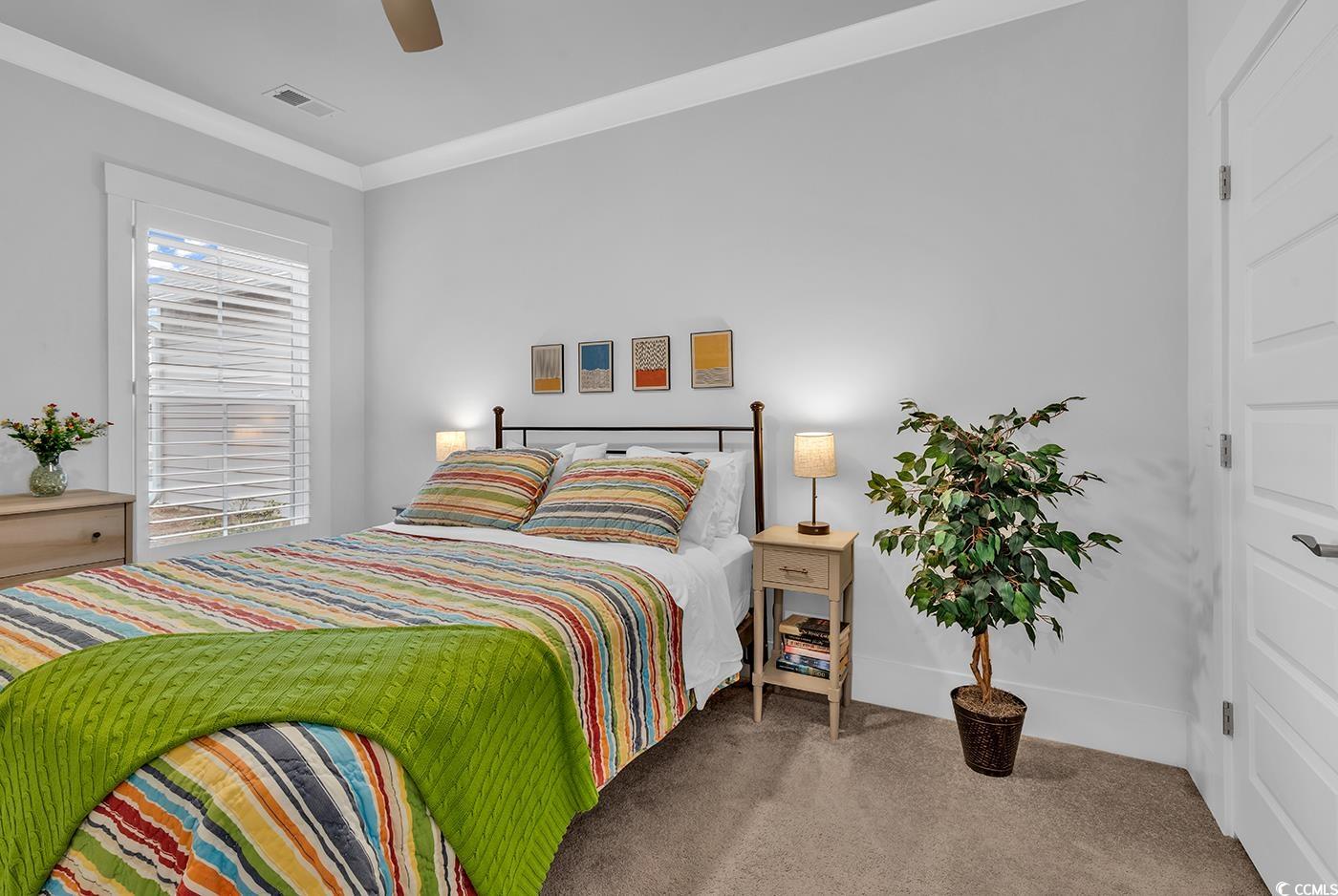 6013 Tramonto Street Myrtle Beach, SC 29577 - Photo 11 of 40 Bedroom with ornamental molding, carpet, and a ceiling fan