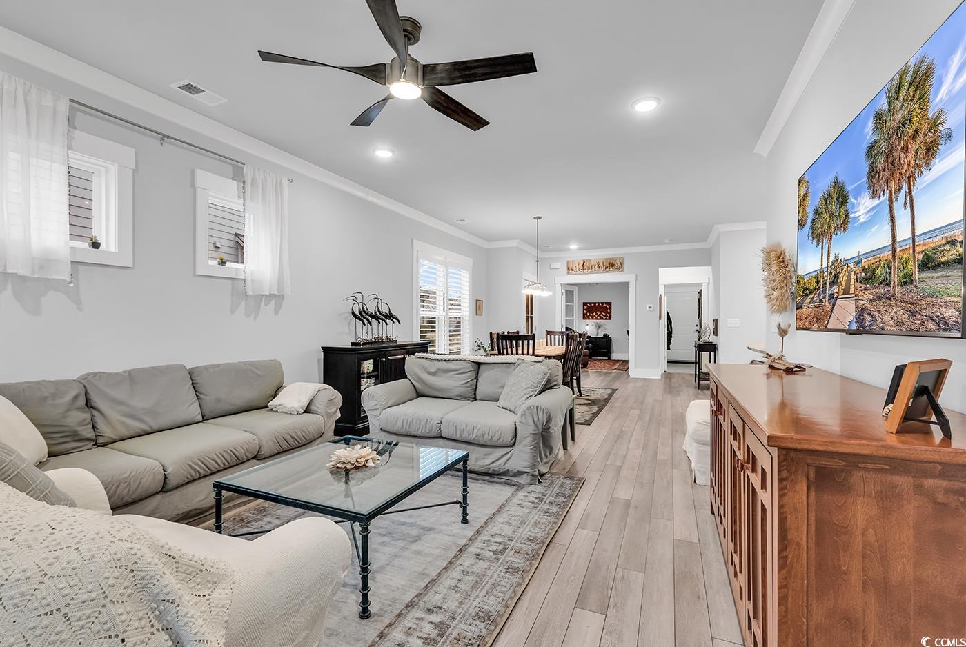 6013 Tramonto Street Myrtle Beach, SC 29577 - Photo 18 of 40 Living area featuring crown molding, ceiling fan, light wood-type flooring, and recessed lighting