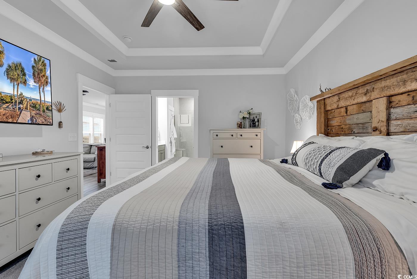 6013 Tramonto Street Myrtle Beach, SC 29577 - Photo 20 of 40 Bedroom featuring a raised ceiling, ceiling fan, and ensuite bath