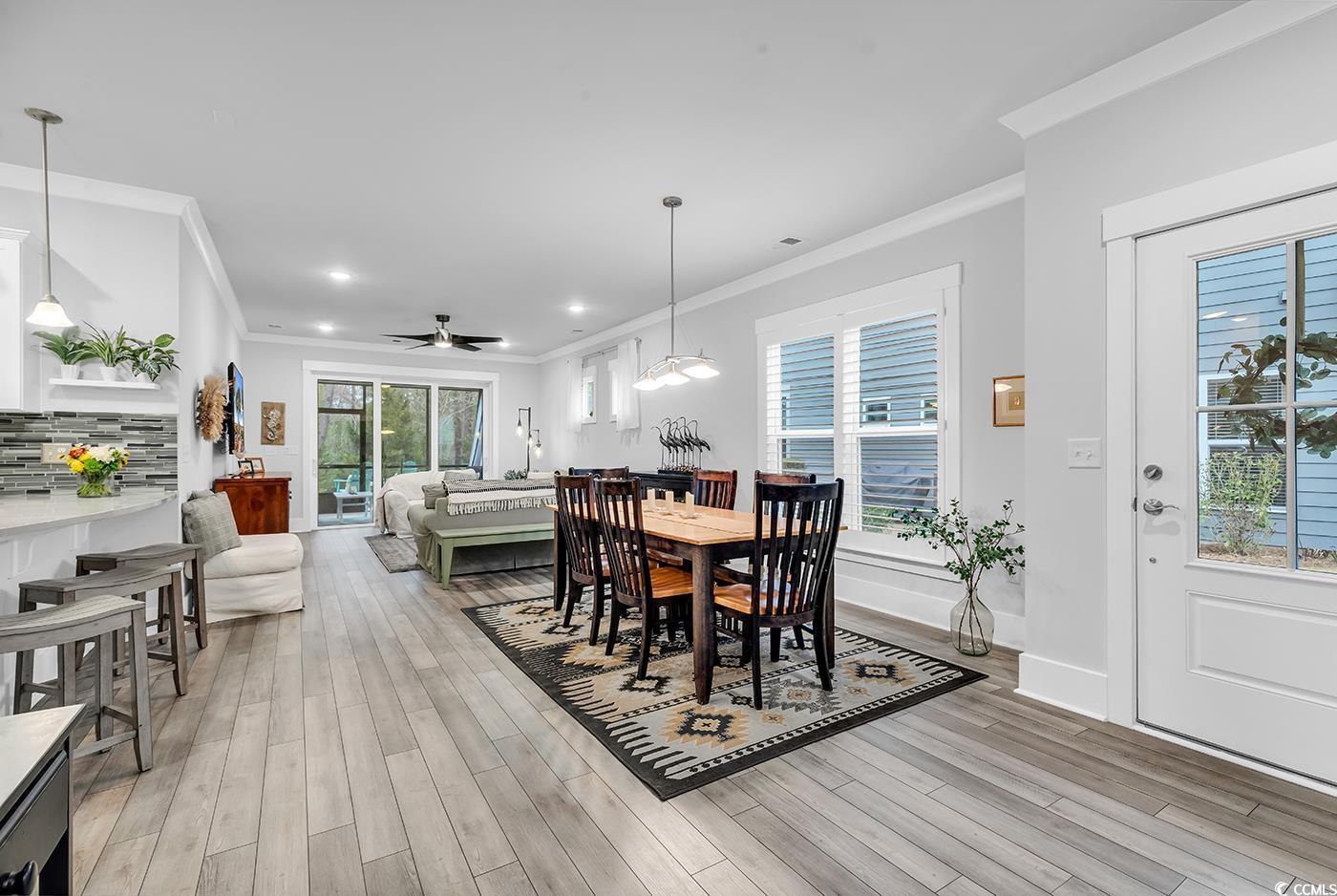 6013 Tramonto Street Myrtle Beach, SC 29577 - Photo 2 of 40 Dining space featuring crown molding, light wood-style flooring, ceiling fan, and recessed lighting