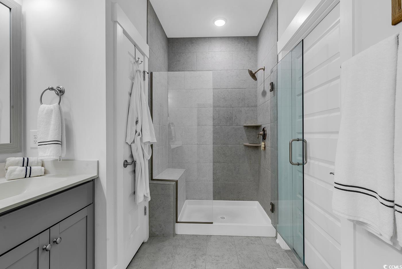 6013 Tramonto Street Myrtle Beach, SC 29577 - Photo 22 of 40 Full bathroom with a stall shower, vanity, and light tile patterned floors