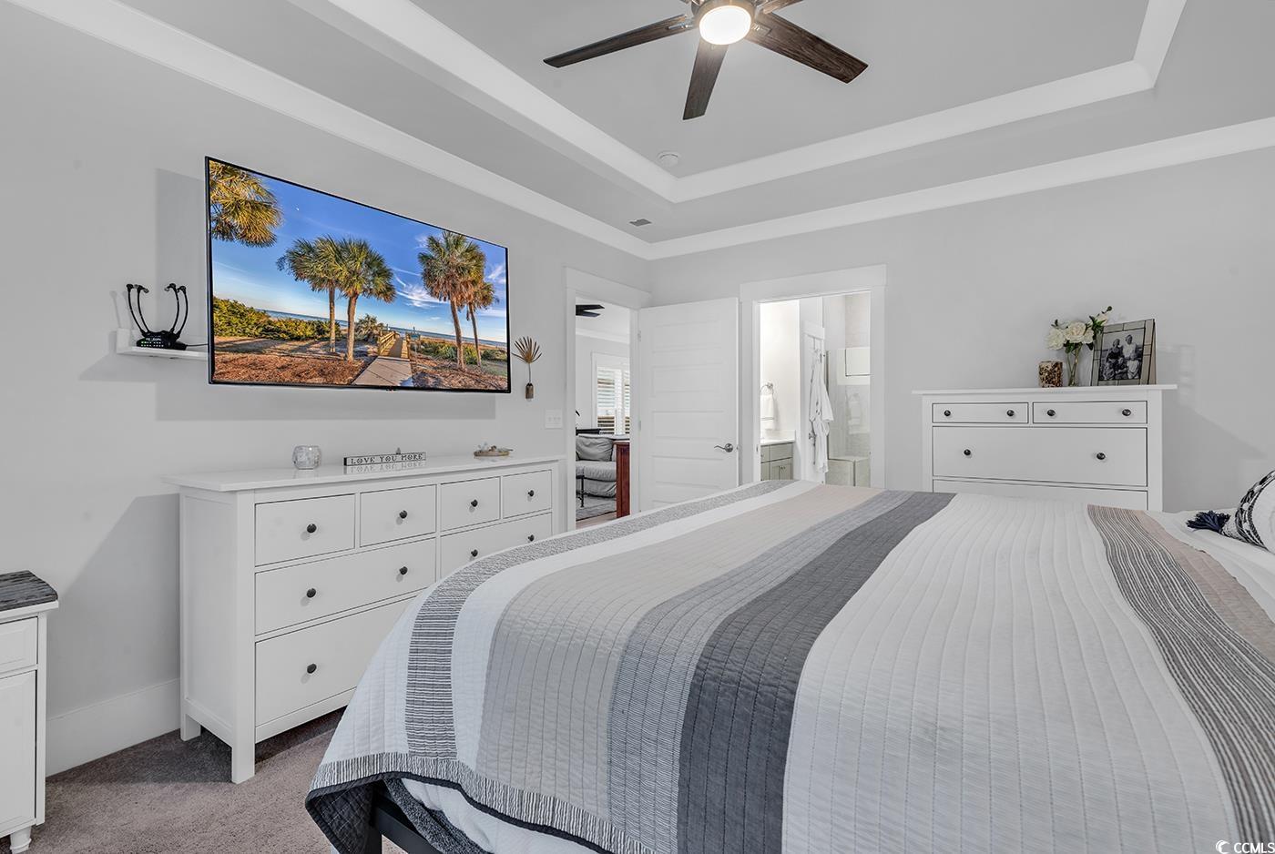 6013 Tramonto Street Myrtle Beach, SC 29577 - Photo 25 of 40 Bedroom featuring a raised ceiling, light carpet, a ceiling fan, and ensuite bath