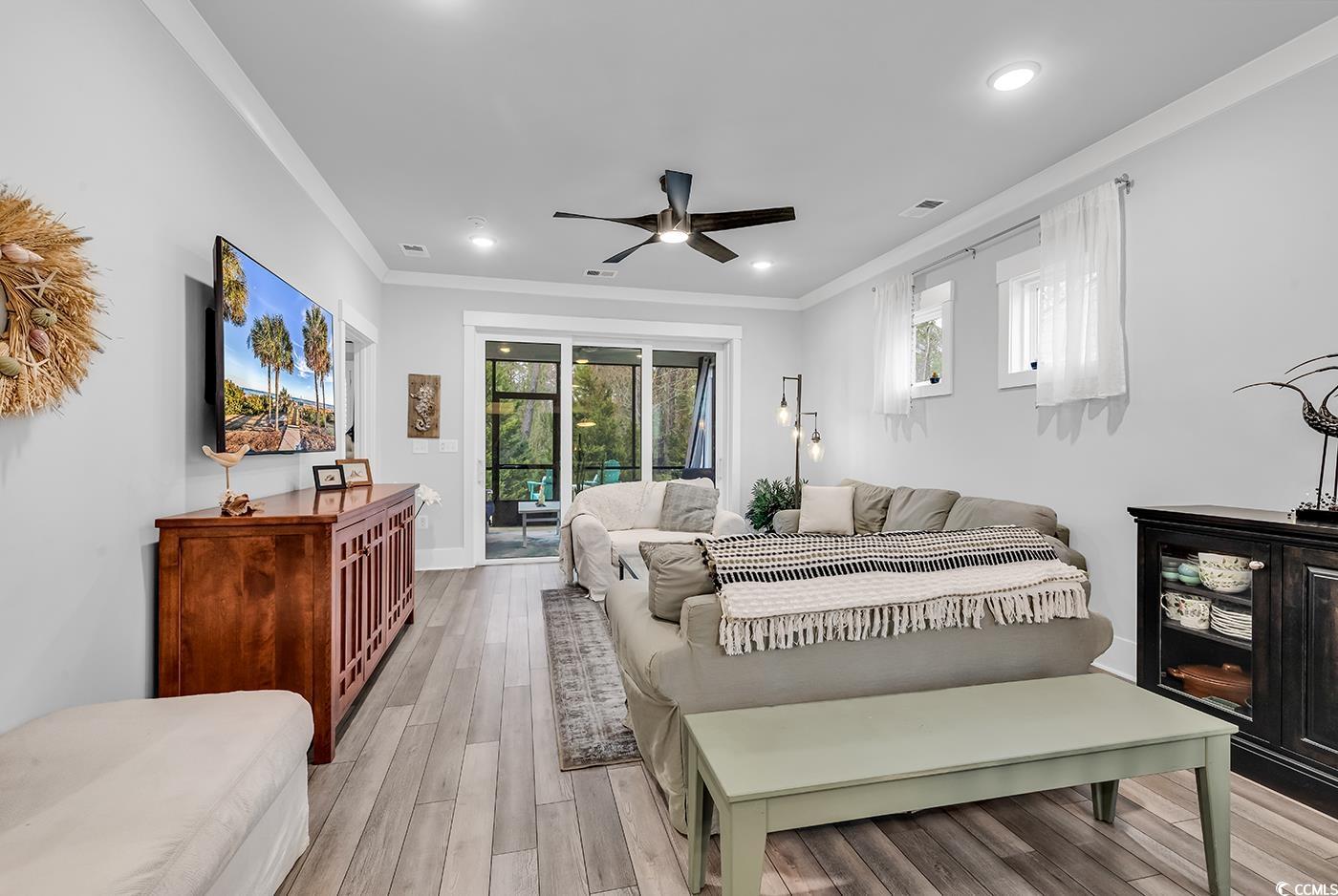 6013 Tramonto Street Myrtle Beach, SC 29577 - Photo 26 of 40 Bedroom with crown molding, multiple windows, wood finished floors, a ceiling fan, and access to outside