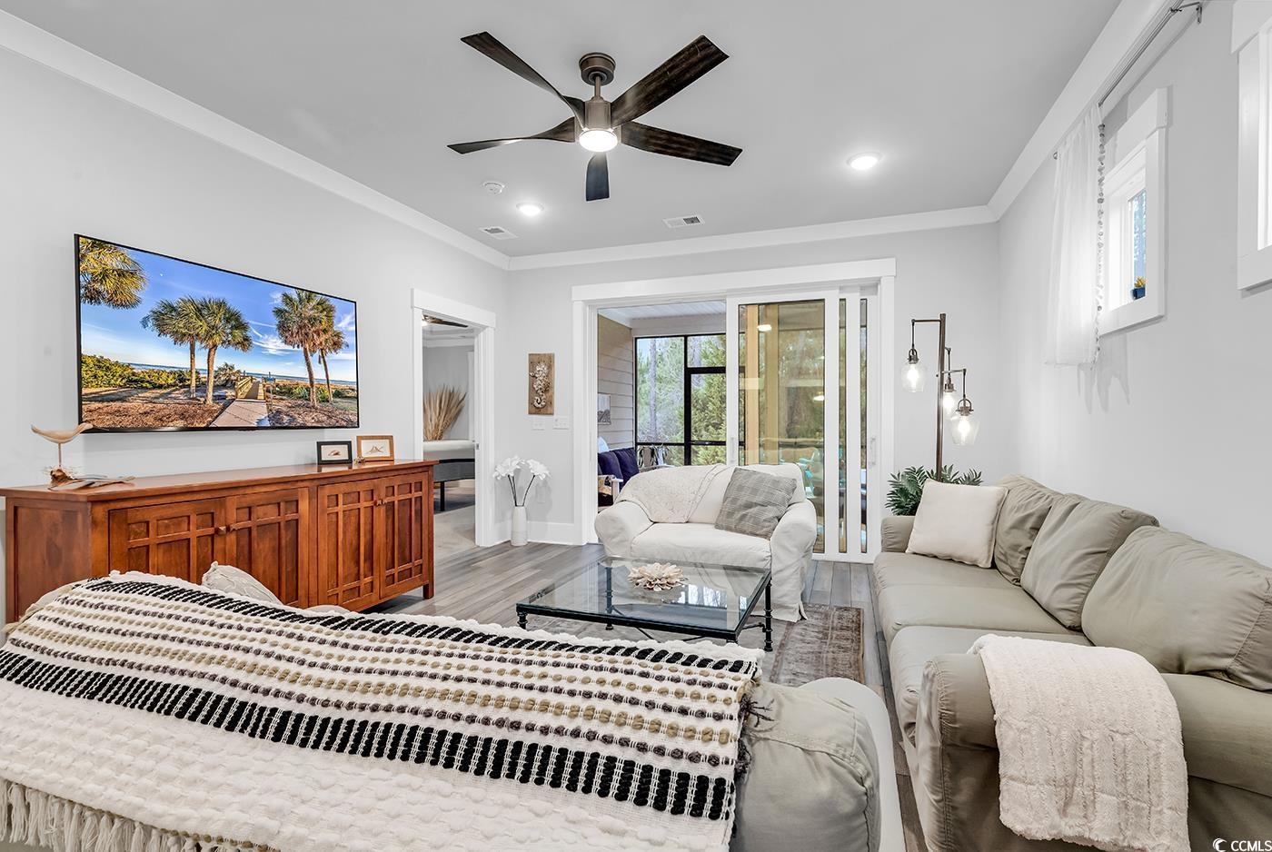 6013 Tramonto Street Myrtle Beach, SC 29577 - Photo 27 of 40 Living area with ornamental molding, wood finished floors, ceiling fan, and recessed lighting