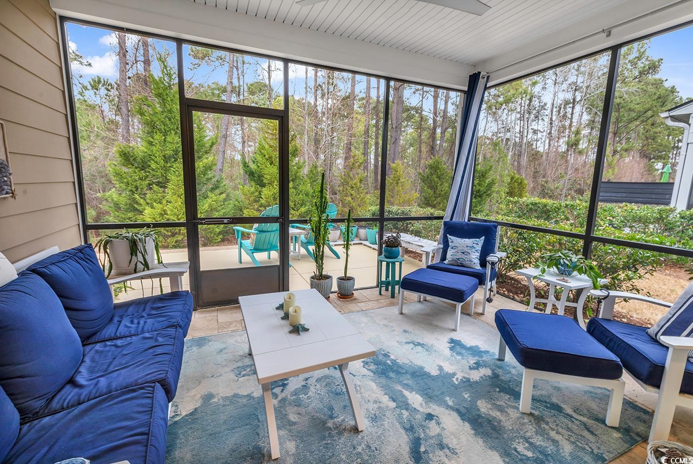 6013 Tramonto Street Myrtle Beach, SC 29577 - Photo 29 of 40 Sunroom / solarium featuring an outdoor living space, healthy amount of natural light, and view of scattered trees