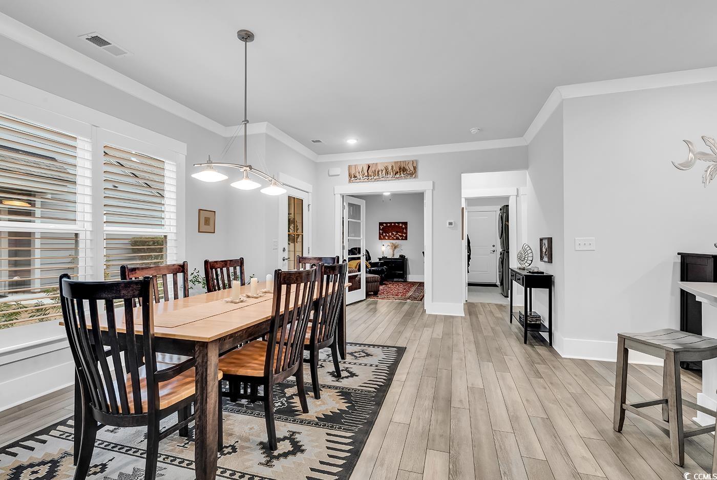 6013 Tramonto Street Myrtle Beach, SC 29577 - Photo 3 of 40 Dining space with ornamental molding and light wood-type flooring