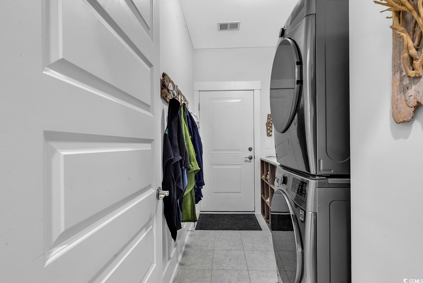 6013 Tramonto Street Myrtle Beach, SC 29577 - Photo 8 of 40 Laundry area featuring light tile patterned floors and stacked washer / drying machine