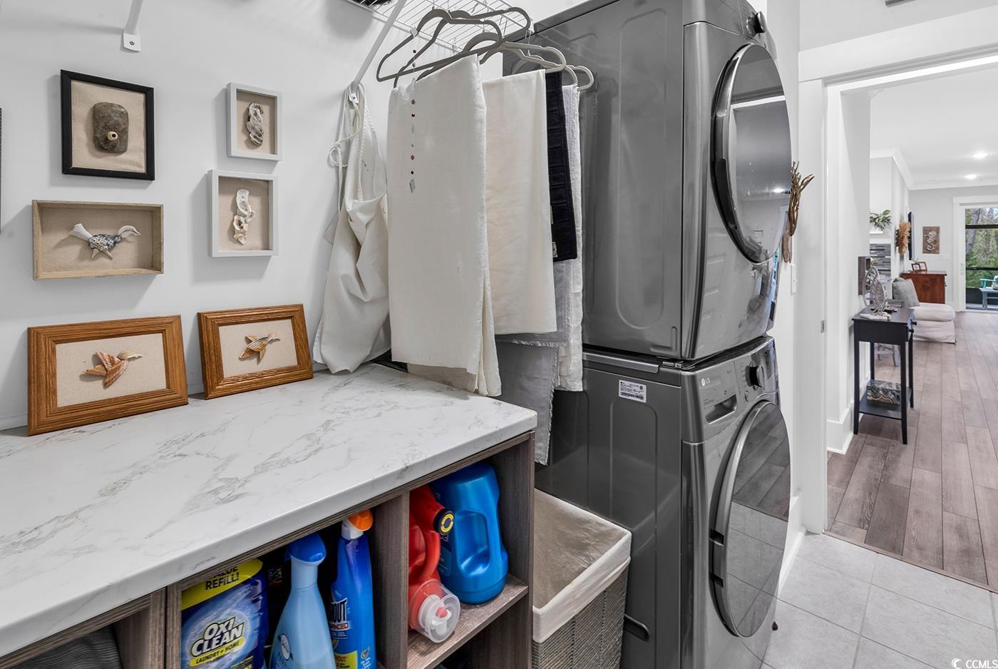 6013 Tramonto Street Myrtle Beach, SC 29577 - Photo 9 of 40 Laundry room with stacked washing machine and dryer and tile patterned flooring
