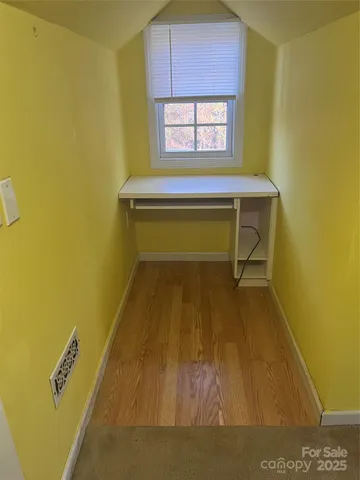a room with a wooden table and chairs