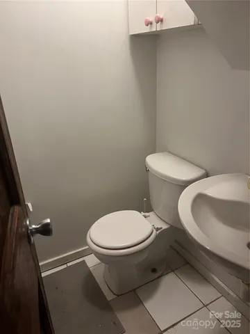 a white toilet sitting next to a bathroom sink