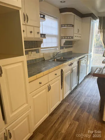 a kitchen with stainless steel appliances a sink and cabinets