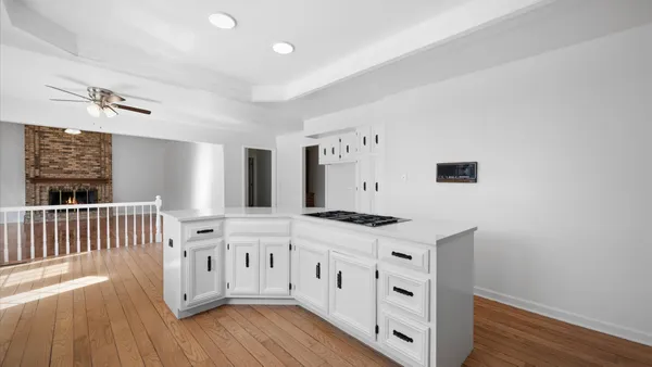 a kitchen with stainless steel appliances cabinets and wooden floor