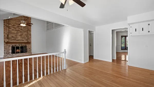 a view of a hallway with wooden floor and entryway