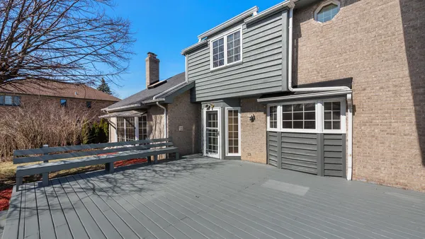 a view of a house with a wooden deck