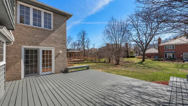 a view of a house with a yard and sitting area