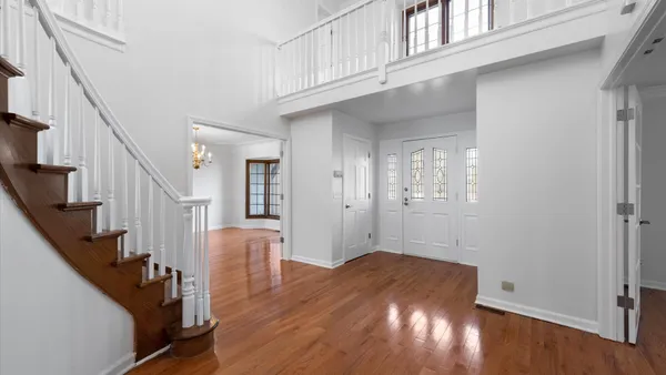 a view of entryway with wooden floor and stairs