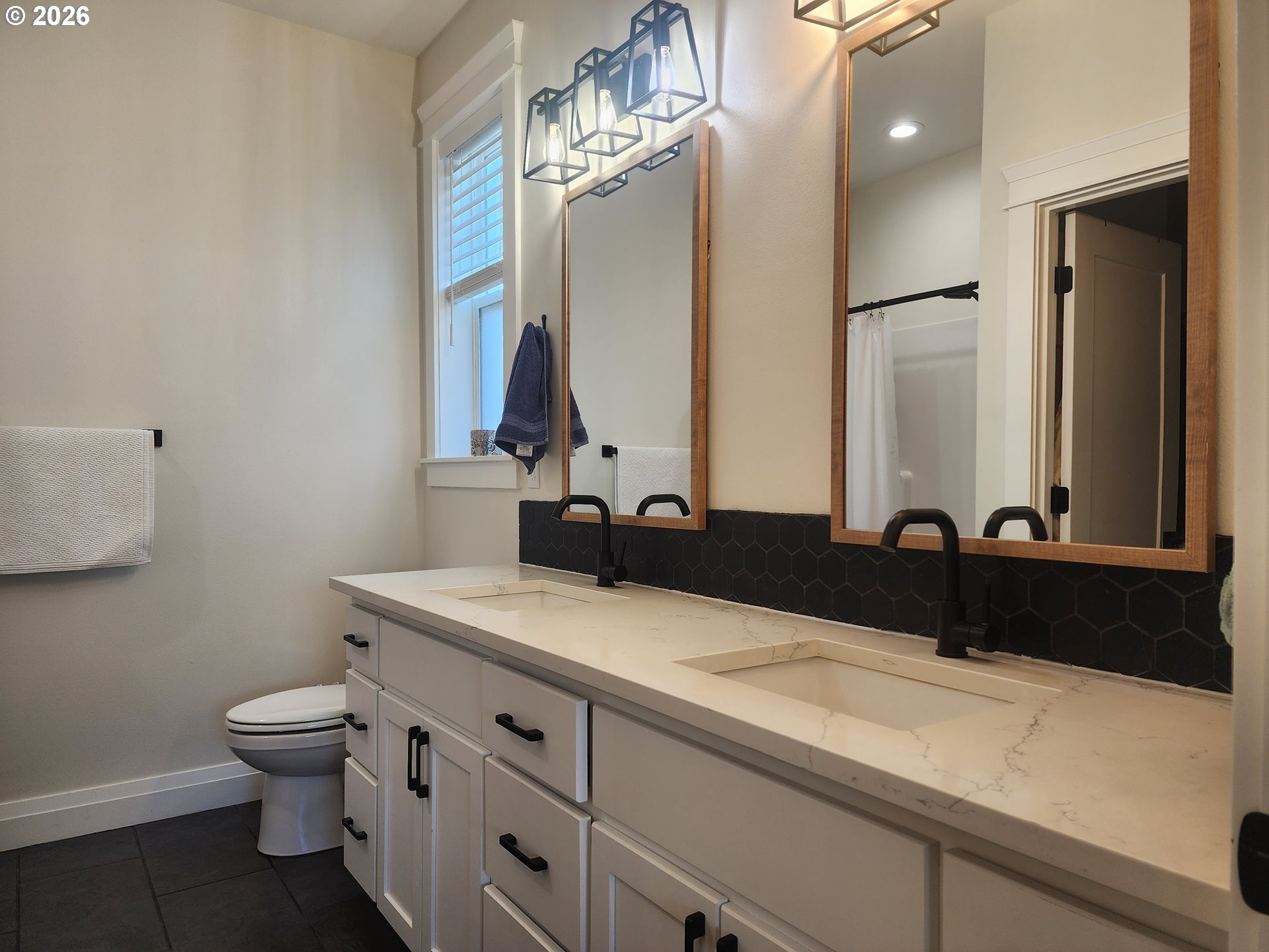 845 1st Street Gervais, OR 97026 - Photo 17 of 29 a bathroom with a granite countertop sink a toilet and a mirror
