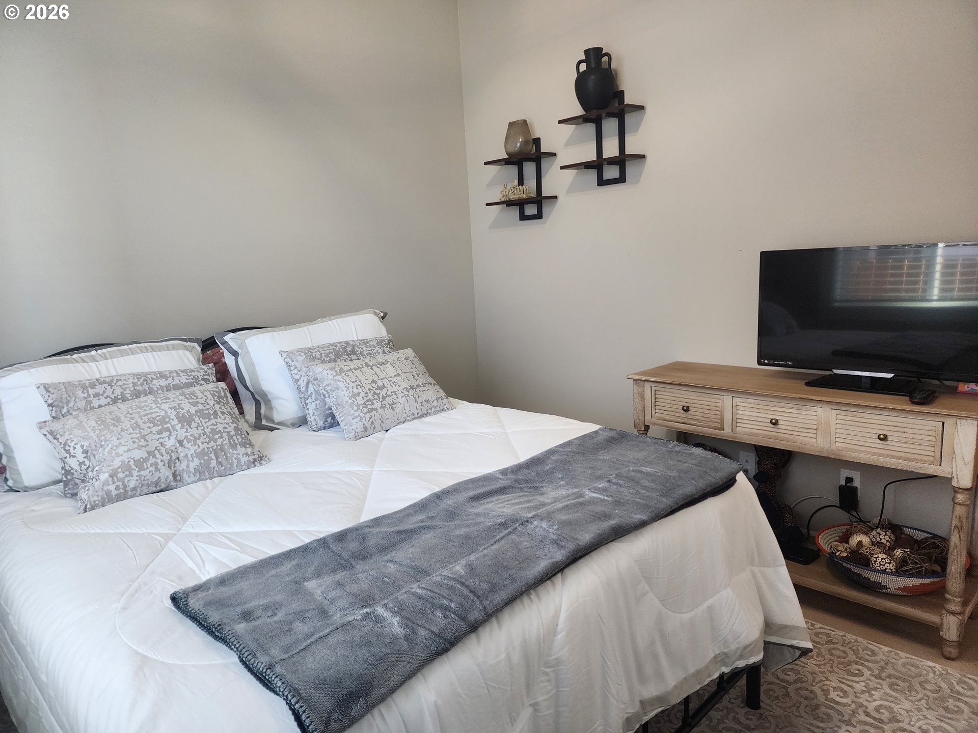 845 1st Street Gervais, OR 97026 - Photo 20 of 29 a bedroom with a bed and a flat screen tv