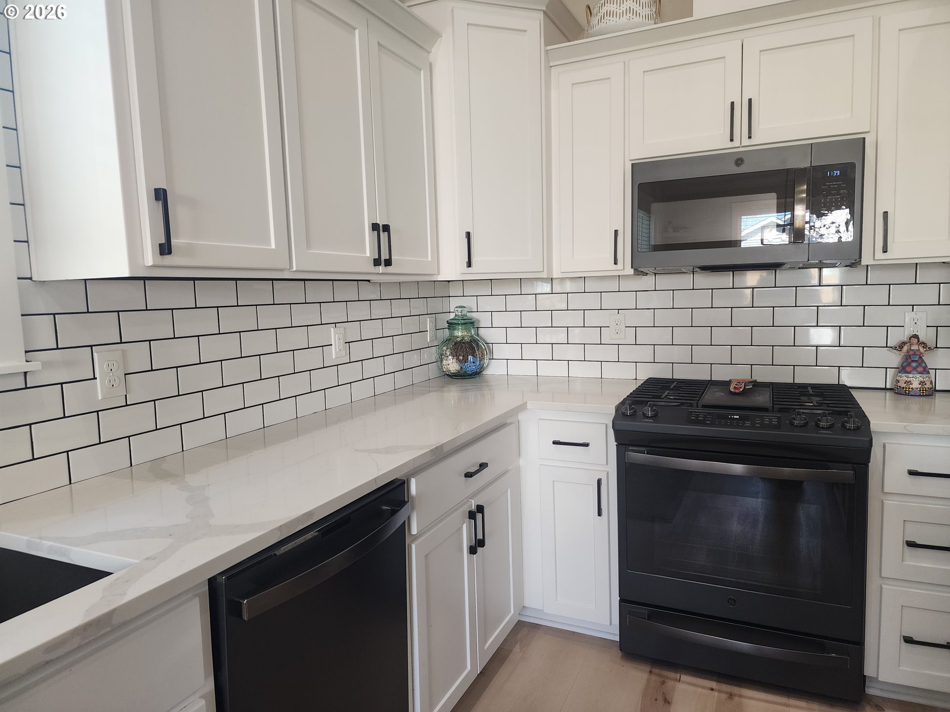845 1st Street Gervais, OR 97026 - Photo 5 of 29 a kitchen with granite countertop white cabinets and stainless steel appliances