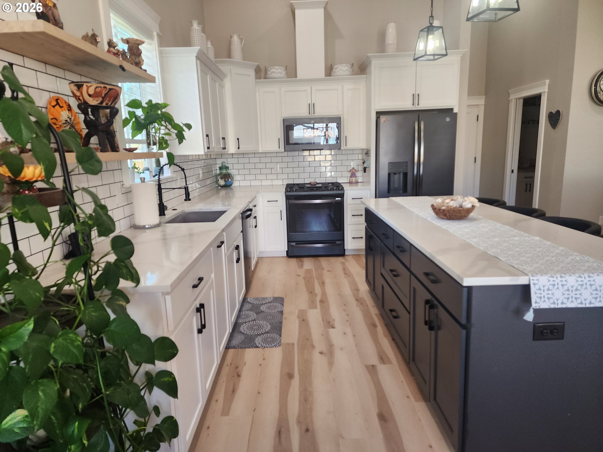 845 1st Street Gervais, OR 97026 - Photo 6 of 29 a kitchen with kitchen island granite countertop a sink stove and refrigerator