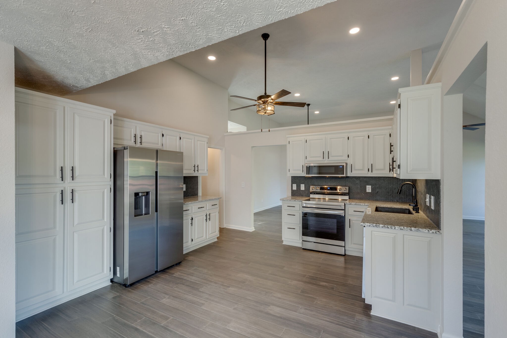 3648 Mahlon Moore Road Spring Hill, TN 37174 - Photo 11 of 30 a kitchen with refrigerator a stove and wooden floor