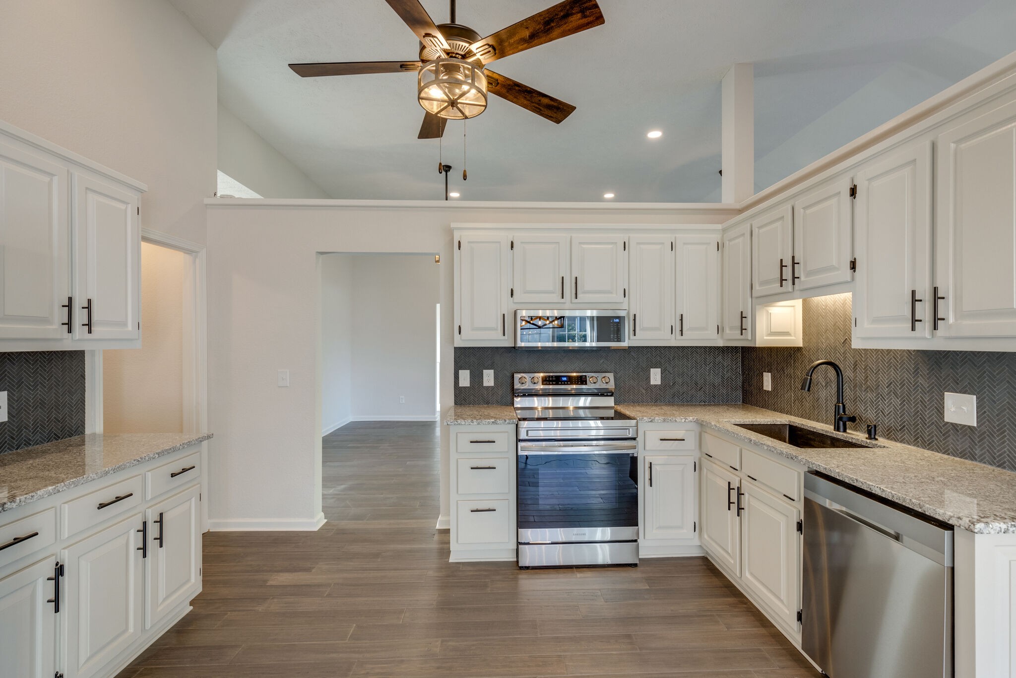 3648 Mahlon Moore Road Spring Hill, TN 37174 - Photo 14 of 30 a kitchen with stainless steel appliances granite countertop a stove and cabinets