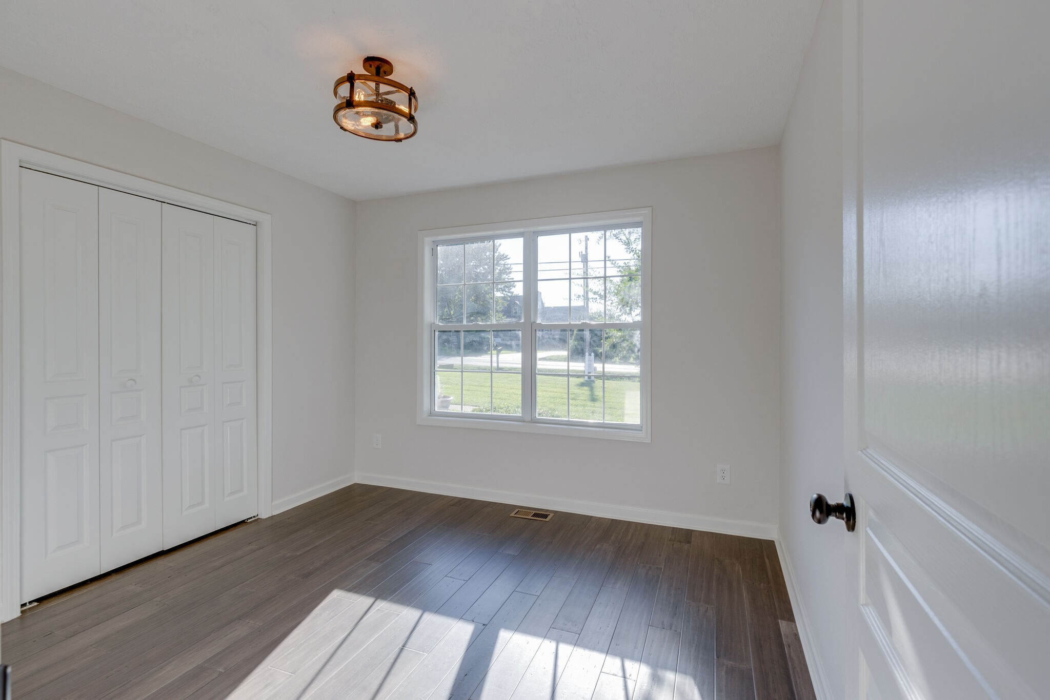 3648 Mahlon Moore Road Spring Hill, TN 37174 - Photo 20 of 30 an empty room with wooden floor and windows