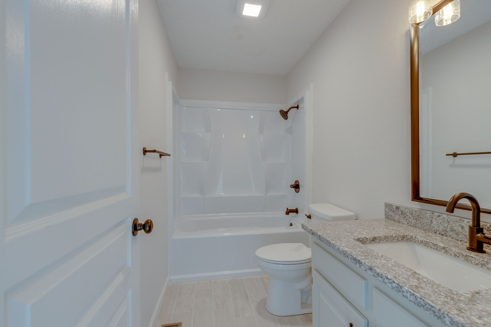3648 Mahlon Moore Road Spring Hill, TN 37174 - Photo 23 of 30 a bathroom with a granite countertop sink a toilet and bathtub