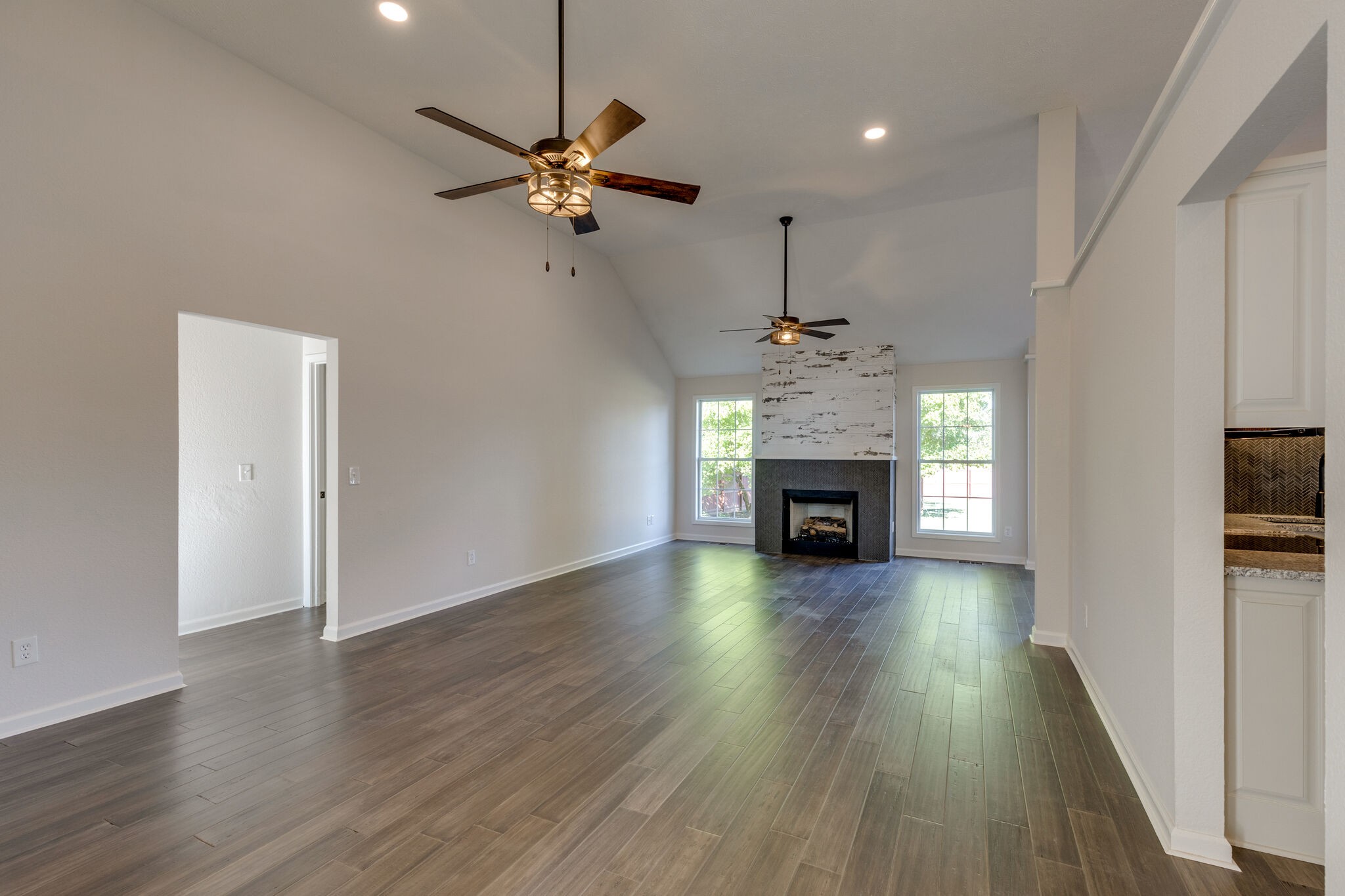3648 Mahlon Moore Road Spring Hill, TN 37174 - Photo 6 of 30 a view of a livingroom with a fireplace a chandelier and wooden floor