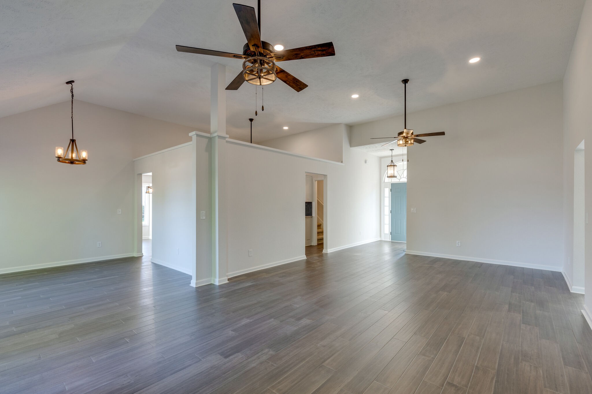 3648 Mahlon Moore Road Spring Hill, TN 37174 - Photo 8 of 30 an empty room with wooden floor ceiling fan and kitchen view