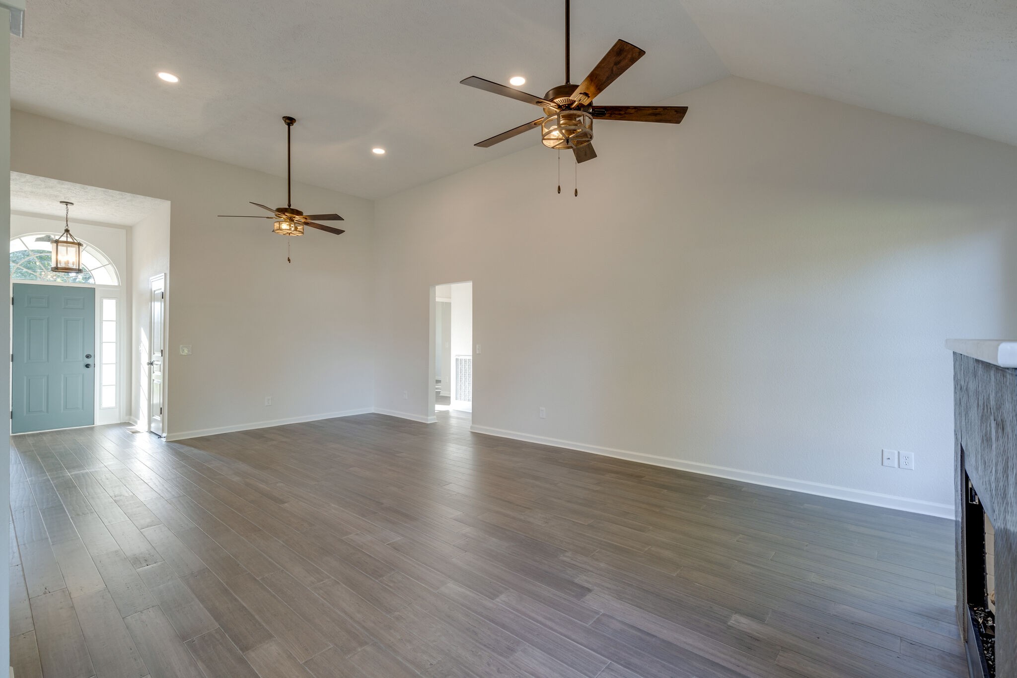 3648 Mahlon Moore Road Spring Hill, TN 37174 - Photo 9 of 30 an empty room with wooden floor fan and windows