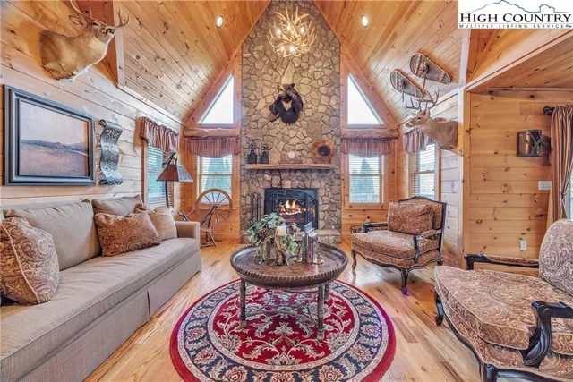 a living room with furniture a fireplace and a chandelier