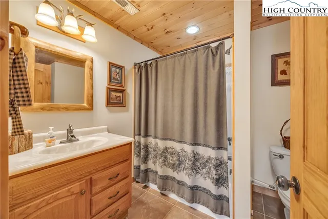 a bathroom with a double vanity sink mirror and shower