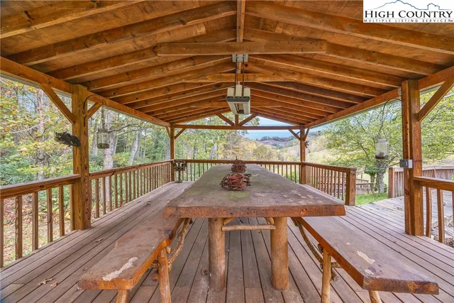 a view of balcony with wooden floor and iron fence