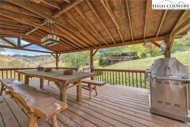 a view of a balcony with chairs and wooden floor