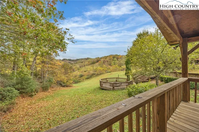 a view of a two tub next to a yard with wooden fence