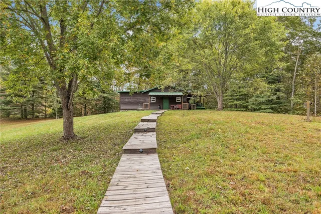 a swimming pool with outdoor seating and yard