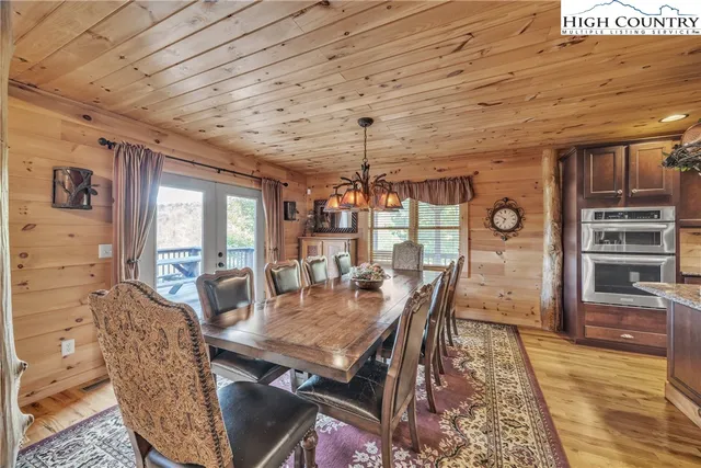 a dining room with furniture window and wooden floor