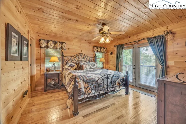 a bedroom with a large bed and a large window