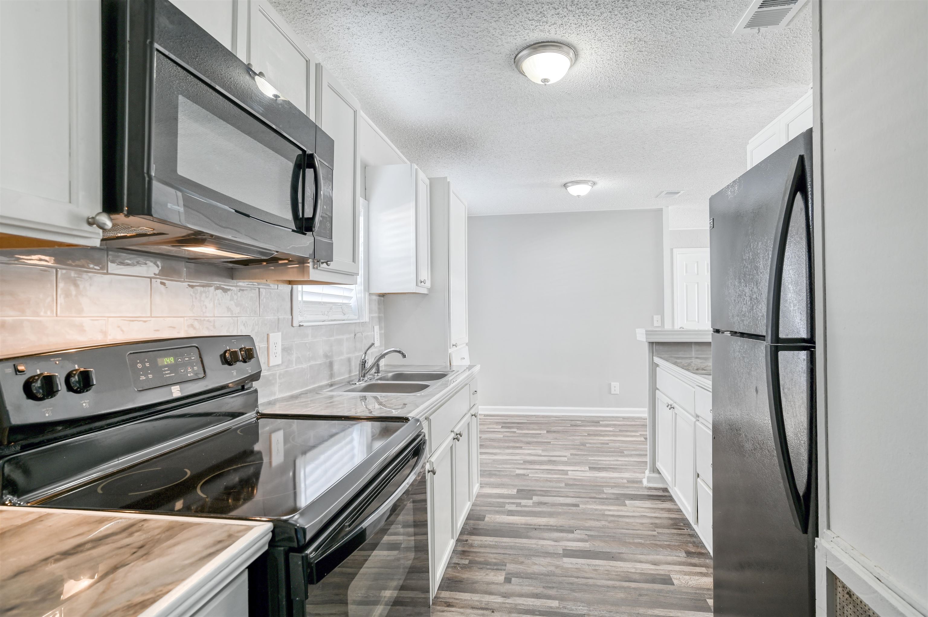 4661 Second Avenue St. Augustine, FL 32095 - Photo 12 of 26 a kitchen with a stove and a microwave