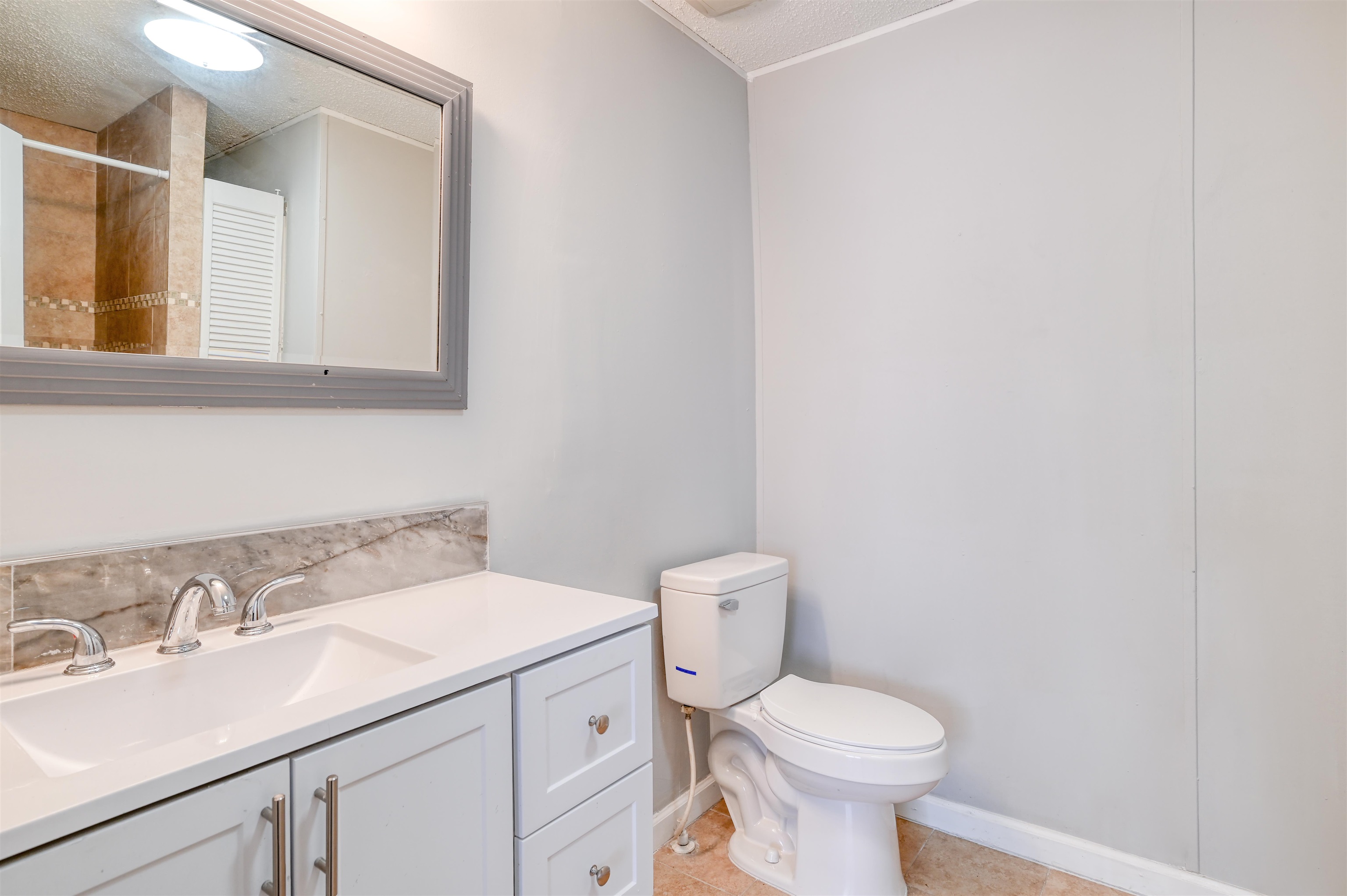 4661 Second Avenue St. Augustine, FL 32095 - Photo 15 of 26 a bathroom with a sink toilet and a mirror